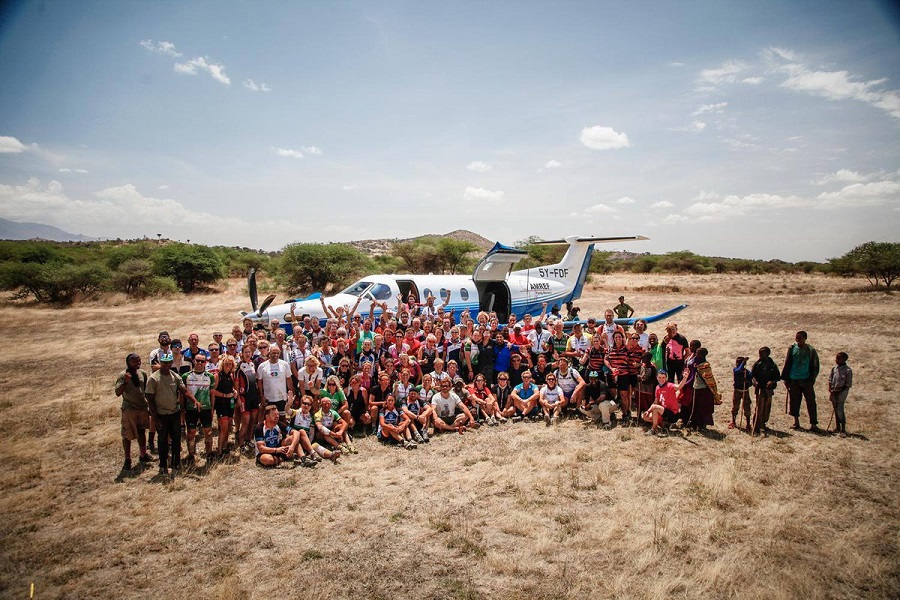 Africa Classic | Tanzania | group of people in front of small plane at steppe | MultidayMTB